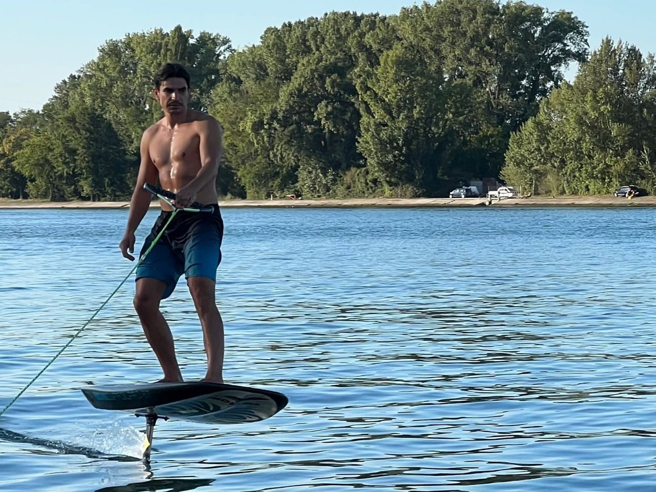 Foilen auf dem Rhein hinter dem Motorboot in Basel